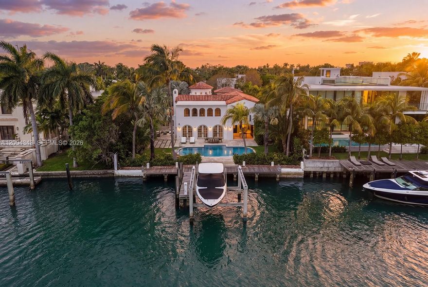 Behind a gated entrance on coveted Pine Tree Drive, this beautifully renovated waterfront retreat unfolds as a private sanctuary on a 12,920 SF lot with 76 feet of water frontage. Lush landscaping and understated elegance set the tone, while wide water views create a serene backdrop throughout. Light-filled, open living spaces with wide plank oak flooring flow seamlessly indoors to out, with expansive terraces & outdoor living areas.  This home is made for effortless entertaining with a luxurious bar featuring natural stone and custom millwork. Unwind out by your sparkling pool & take in cool bay breezes. This 5-bedroom, 5.5-bath home offers comfort and refinement, featuring 4 bedrooms in the main residence and a separate guest house with an additional bedroom for visitors. Upstairs, the oversized principal suite is a tranquil oasis with a striking marble bath and double height ceilings. Enjoy living in this tropical haven in the heart of Miami Beach.