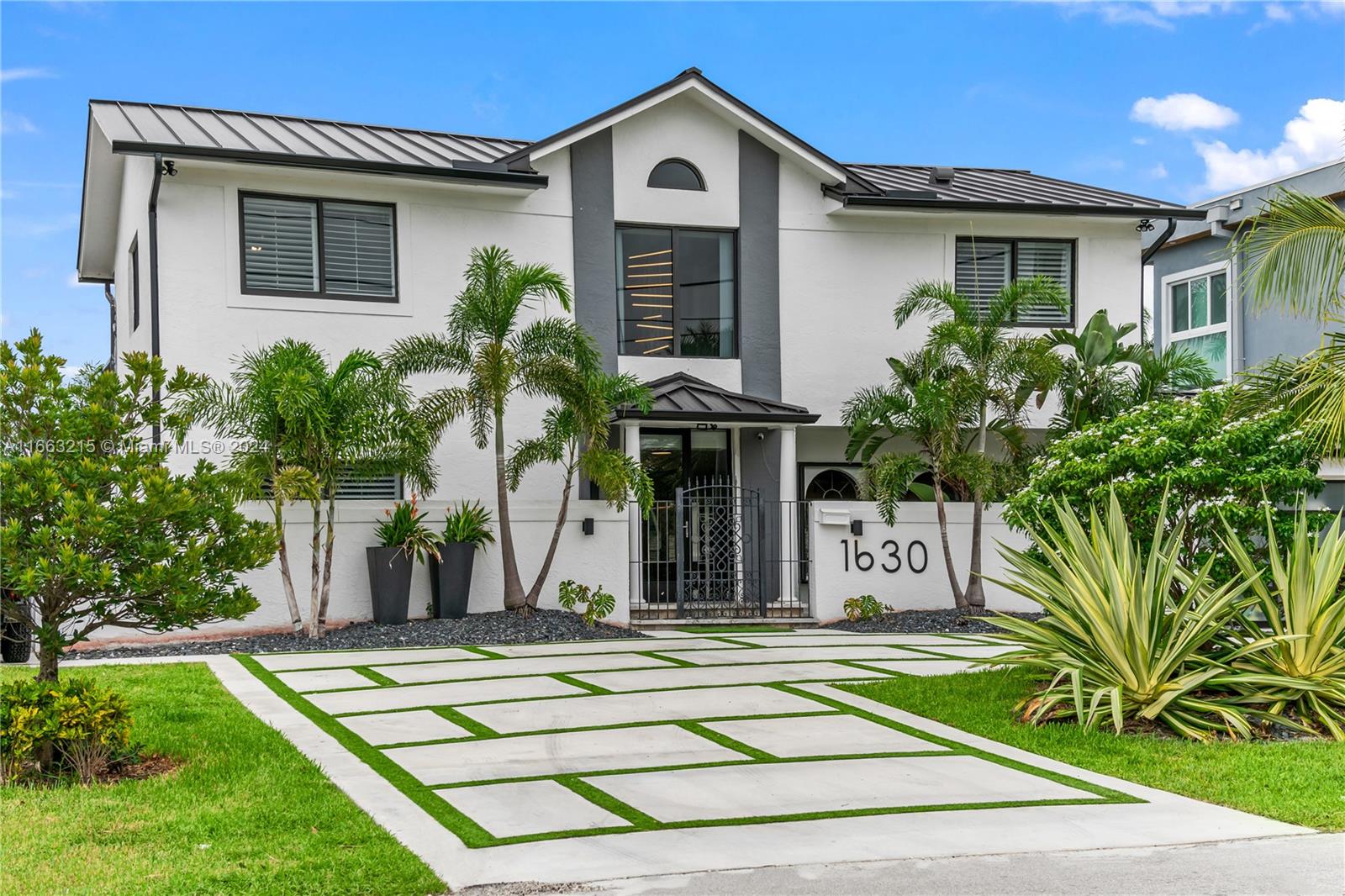 BACK ON THE MARKET-PRICE REDUCED: BRING YOUR OFFER. Situated along the intersection of two canals, this contemporary residence epitomizes luxury & comfort. With over 2700 SF, this home offers 3 oversized bdrms, 3 full baths & lots of natural light. All 3 bedrooms have added space for sitting or play areas, with custom closets for ample storage. The home is equipped with essential updates for peace of mind: New metal roof, A/C, HWH & alarm system, complete with cameras. The screened pool patio is equipped with child safety fence and beckons for leisurely afternoons. The backyard is turfed & the dock along the canal is great for fishing. The front exterior features a walled walkway leading to the laundry/storage room and a putting green for added recreation. Schedule viewing today!