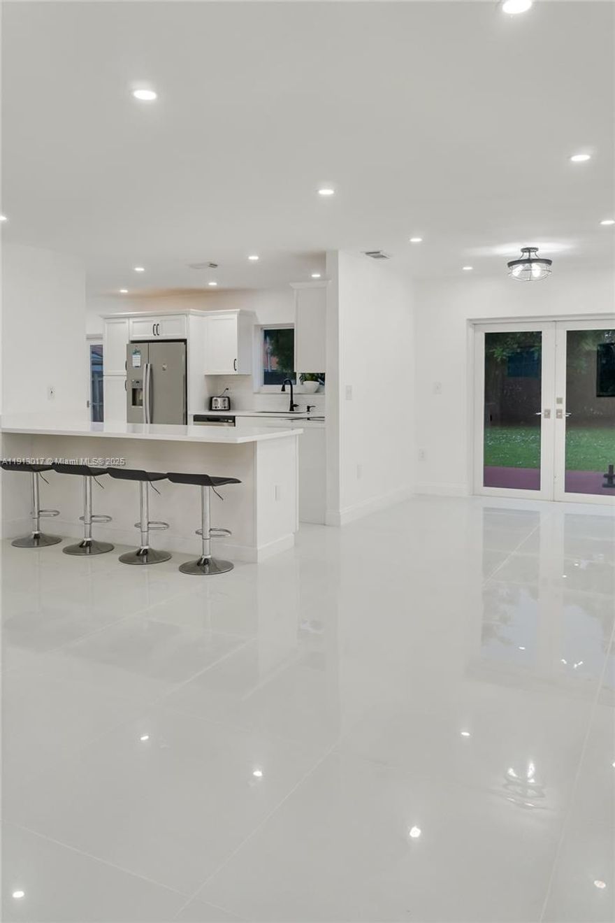 Discover refined living in this fully renovated 5 bedroom residence set on a private end lot with nearly 9,000 sq. ft. of land. Step inside to an open, light filled design featuring a brand new kitchen with elegant finishes, glossy white tile floors that create a grand sense of space, and warm wood laminate flooring upstairs for a modern touch. The expansive backyard offers endless potential perfect for gatherings, a pool, or your dream outdoor retreat. A rare blend of privacy, luxury, and everyday comfort.