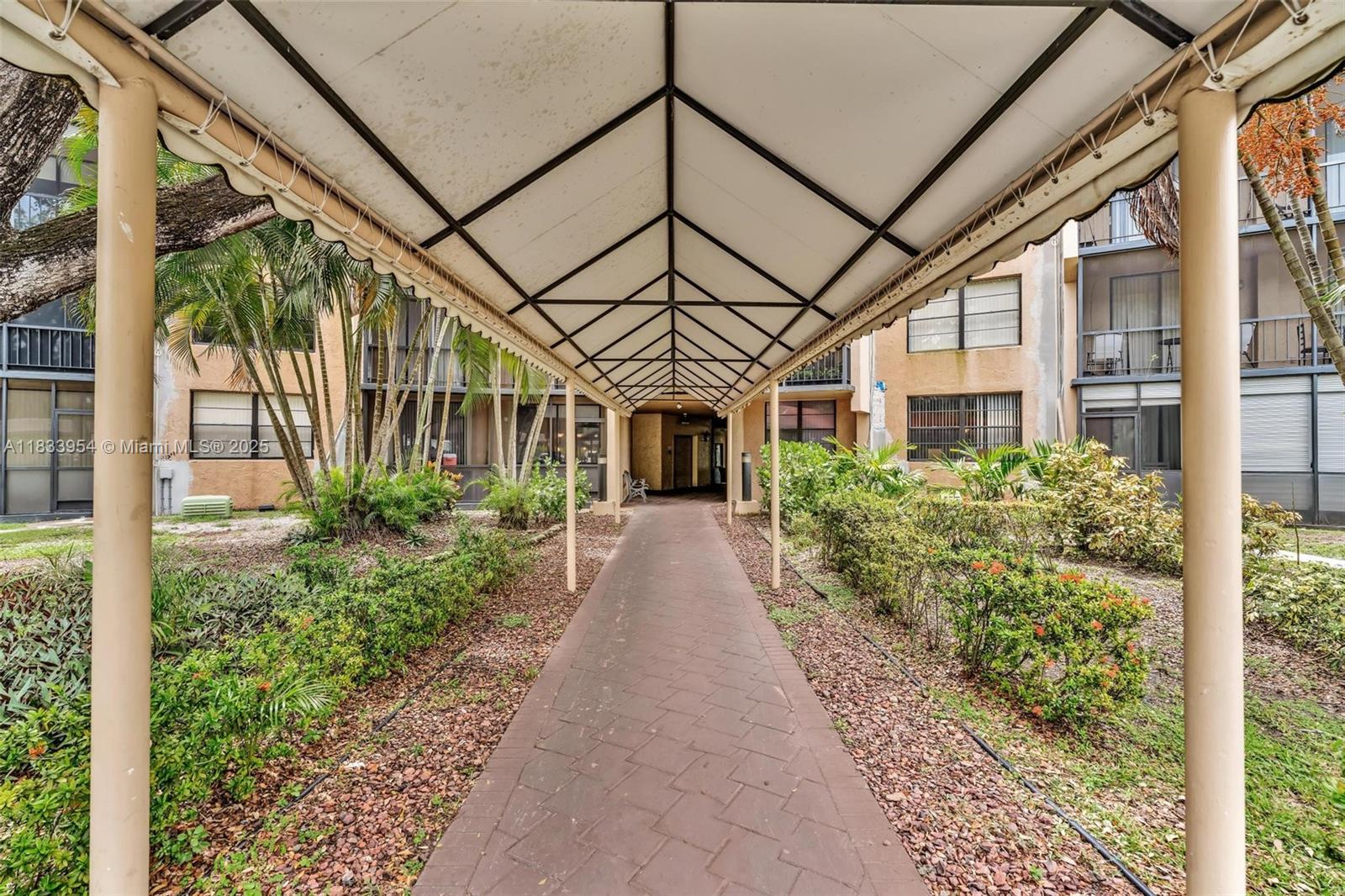 This beautifully updated 1 Bed / 1 Bath unit offers breathtaking views of the 10th hole at Emerald Hills Country Club. Featuring a fully renovated kitchen with sleek stainless steel appliances, this home is perfect for modern living. The patio boasts sliders and hurricane shutters for added protection. Inside, you'll find elegant wooden interior doors, baseboards, and a spacious walk-in closet. The master bath area features a stylish mirrored wall, adding a touch of luxury. Conveniently located near houses of worship, major highways, the airport, and the beach, this property is perfect for both relaxation and accessibility.