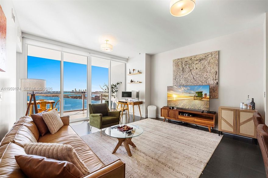 Turnkey 1-bed + den residence at Paramount Bay featuring floor-to-ceiling windows with stunning unobstructed bay views and 10ft ceilings. This elegant unit offers private elevator and foyer access, a spacious terrace perfect for entertaining, and modern kitchen with sleek finishes. The master suite includes a walk-in closet and bathroom with dual sinks. In-unit washer/dryer included. Residents enjoy resort-style amenities including sunrise and sunset pools, spa, fitness center, theater, BBQ area, game room, club room, and full-service concierge. Prime location in the heart of Miami's Edgewater ensures effortless access to vibrant dining, shopping, and entertainment options, complemented by the nearby scenic Margaret Pace Park and close to Miami Beach and Downtown.