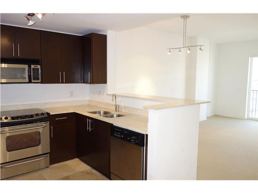 Beautiful building centrally located in Coral Gables, one block from Miracle Mile. Walk to restaurants, shopping and entertainment. Unit features marble and carpeted floors, large walk-in closet, updated bath and kitchen with stainless steel appliances an d marble countertops, washer/dryer, 2 balconies. Amenities include 24 hr security, pool, gym, business center, and lounge. This special unit comes with 2 parking spaces. Small dog allowed.