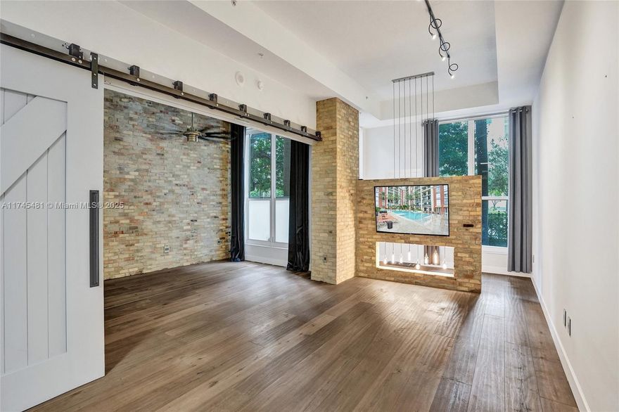 One-of-a-kind 1st floor unit with 12' ceilings in one of downtown WPB's premier buildings. Open floorplan with incredible upgrades including reclaimed brick walls, wide-plank wood flooring, 13' wide custom barn doors (creating a separate sleeping area when closed), concrete counter tops and private direct exterior entry which is perfect for pets. Assigned, covered parking on 1st floor steps from unit. CPST is a resort-style, full service luxury building with a 24-hr concierge/doorman, valet, infinity pool, fitness center, sauna/steam/massage rooms, outdoor/indoor kitchens and lots more! All is included in HOA payment along with exterior ins, water, cable & internet. The Square, Kravis Center, Brightline station and Convention center right outside your door. 1.5 miles to beach