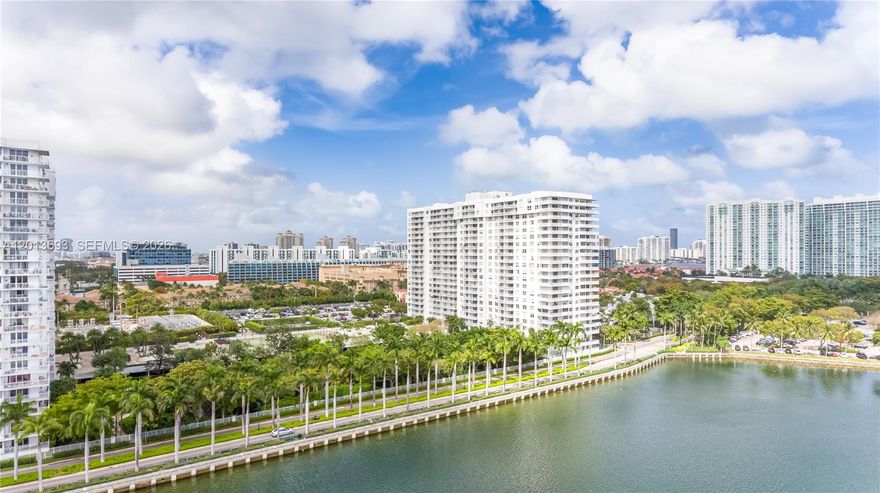 IMMEDIATE OCCUPANCY / VACANT END OF MAY! Skip the wait and move right into this spectacular, fully renovated high-floor residence at Admirals Port. Spanning over 1,460 sq. ft., this bright, spacious, and completely vacant 2-bedroom, 2-bathroom home is an immaculate blank canvas ready for your personal touch. Features include modern light-reflecting flooring throughout, contemporary recessed LED lighting, and a custom built-in dry bar with an integrated wine cooler. The gorgeous open-concept kitchen is equipped with high-gloss white cabinetry, smart LG ThinQ appliances, and premium quartz countertops with a dramatic waterfall edge. The primary suite offers a customized walk-in closet and a spa-like bath with a custom blue-onyx porcelain rain shower and backlit LED mirrors. Step onto the private balcony to enjoy a dynamic, high-floor view overlooking the active tennis courts and resort pool directly below, with a beautiful lateral view of Maule Lake opening up to the left. Important Note for Buyers: The tenant is departing at the end of May 2026, making this unit perfect for owner-occupants wanting immediate occupancy. The building requires 1 year of ownership before renting, ensuring a quiet, stable, and highly desirable residential community. Minutes to Aventura Mall, fine dining, and houses of worship. Easy to show and ready for a fast closing!