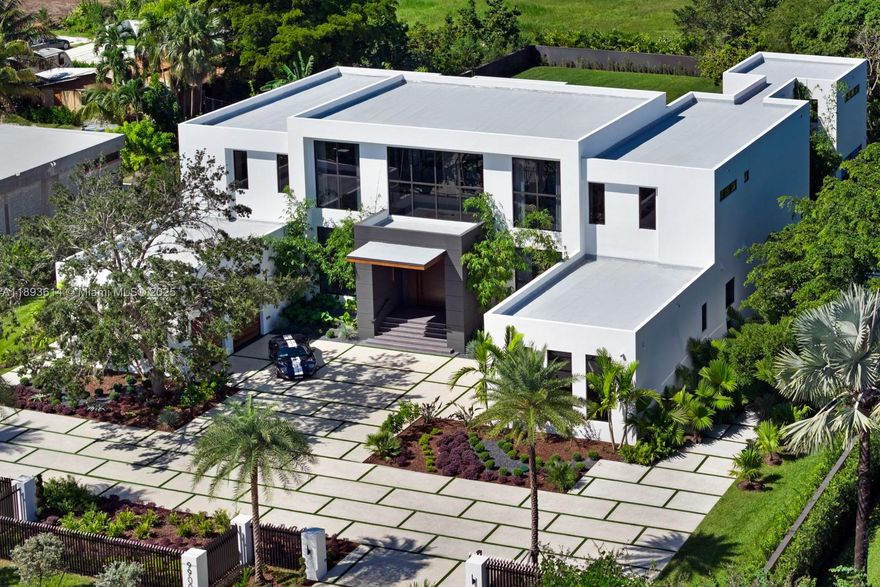 A statement of modern architecture & artistry, this 2025 estate reimagines luxury living on over an acre of resort-caliber grounds. Spanning 12,000+ sq ft, including a 1,000 sq ft guest home, every inch reflects uncompromising design & craftsmanship. Soaring 28 ft ceilings, custom murals, a floating glass staircase, private elevator, & showpiece fireplace define its elegance & scale. The chef’s kitchen, Lutron automation, & full smart-home integration blend innovation with comfort. 14 ft high garage bays fit multiple lifts. The primary wing unveils a private terrace & custom closets. Outdoors rival a five-star resort with a full summer kitchen, covered pavilions, poolside lounge, & expansive grounds ideal for courts or gardens. A true jewel—extraordinary, extravagant, & undeniably refined.