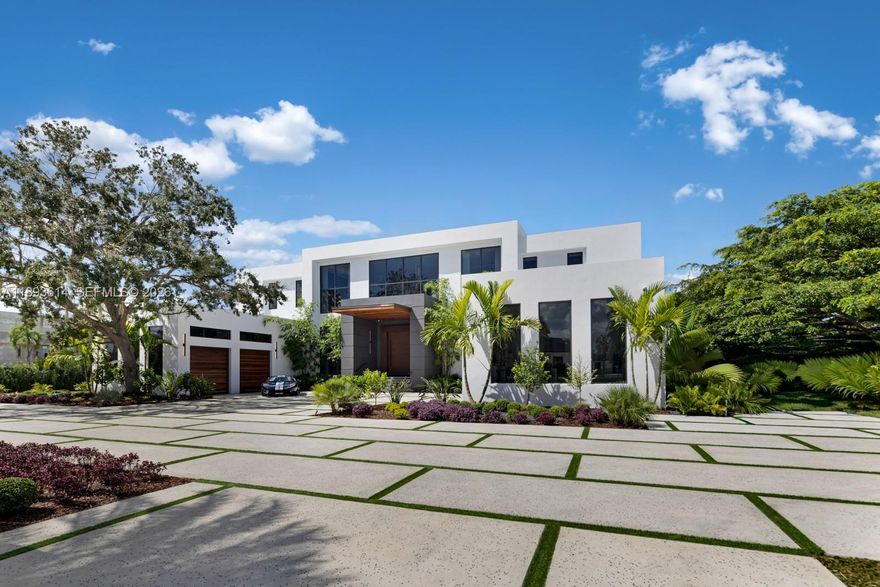 A statement of modern architecture & artistry, this 2025 estate reimagines luxury living on over an acre of resort-caliber grounds. Spanning 12,000+ sq ft, including a 1,000 sq ft guest home, every inch reflects uncompromising design & craftsmanship. Soaring 28 ft ceilings, custom murals, a floating glass staircase, private elevator, & showpiece fireplace define its elegance & scale. The chef’s kitchen, Lutron automation, & full smart-home integration blend innovation with comfort. 14 ft high garage bays fit multiple lifts. The primary wing unveils a private terrace & custom closets. Outdoors rival a five-star resort with a full summer kitchen, covered pavilions, poolside lounge, & expansive grounds ideal for courts or gardens. A true jewel—extraordinary, extravagant, & undeniably refined.