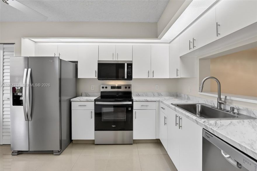 Wake up each day in a Peaceful, quiet setting while knowing a vibrant world of Amenities is available whenever you choose to enjoy it. Beautifully upgraded first floor condo offering not just comfort and style, but an exceptional lifestyle within Century Village Pembroke Pines. The association fee provides access to one of South Florida’s most amenity-rich 55+ communities, featuring a spectacular 1,042-seat Theater with Broadway-style performances, fitness centers, indoor and outdoor pools, sauna rooms, pickleball and tennis courts, billiards and card room, a library, and countless clubs and activities—all designed to enhance residents’ well-being and everyday living. The community also features a challenging par-71 Golf course suitable for all skill levels—resort-style living without leaving the gates. An active social Calendar offers something to enjoy Every day.

Upgraded kitchen features 2026 brand-new stainless-steel appliances, countertop, sink, sink faucet and pantry door. Upgraded bathrooms features new vanities, lighted mirrors, bathroom lights, toilets, exhaust fans and shower faucets. Convenient in-unit new washer and dryer. A/C (2024) Freshly painted walls, new vinyl laminated flooring and baseboards throughout. Assigned parking just steps away. 24/7 manned security and two entrance gates. 700 credit score minimum required, no rentals first two years. At least one owner must be 55+