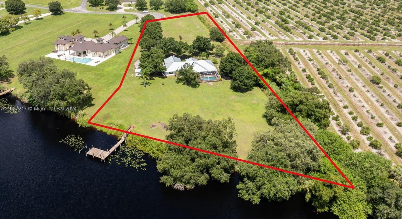Home is a custom-built 5BR/3BA home with new galvalume metal roof, two screened porches, caged pool, and private dock, perfect for a peaceful retreat or vibrant family home. Lot size is 1.87 acres plus benefits from .80+/- acre of Corps Rwy giving a total of 2.67+/- acres of privacy. Home features a split floor plan, fireplace, upgraded kitchen with breakfast bay and renovated bathrooms. Includes a caged pool which is a covered patio and front “rocking chair” screened porch, separate laundry room and oversized two car garage. In a great location just 3 miles from the Lee/Hendry County line for the best of country life with city life at your fingertips! BOAT, FISH AND JUST ENJOY YOUR LIFE ON THE SERENE CALOOSAHATCHEE RIVER, PART OF THE INTRACOASTAL WATERWAY! LET THIS BE YOUR PRIVATE OASIS!