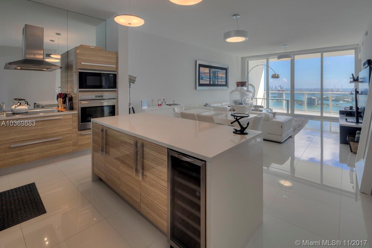 Spectacular 3BD/3BA residence at Paramount Bay! This rarely available 03 line features the largest living room of any floorplan in the building. Enjoy staggering direct bay views from giant floor-to-ceiling windows, 10 ft high ceilings, over 1,800 sq ft of living space, & an expansive master suite. Highly upgraded finishes include Italian porcelain floors throughout, window treatments & closets. Paramount Bay features the best amenities in town, including sunrise & sunset pools, gym, spa, valet, & more.
