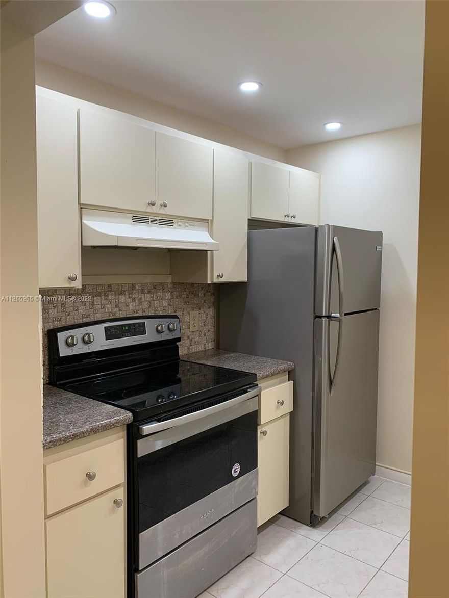 RENOVATED 1BR 1.5BA APARTMENT WITH SPACIOUS BEDROOM, SERENE TENNIS COURT AND GARDEN VIEWS & RELATIVELY CLOSE TO CLUBHOUSE. IT HAS TILE FLOORS, GRANITE KITCHEN COUNTER TOP, STAINLESS STEEL KITCHEN APPLIANCES and TANK-LESS WATER HEATER. The village is guard gated & patrolled with serene walking trails & relaxing outside greenery. You will find golf, tennis, pools, fitness centers, & complimentary transportation available. The apartment is conveniently located next to Pembroke Gardens Shops and Pembroke Lakes Mall. It is a verified HOPA 55+ community.
