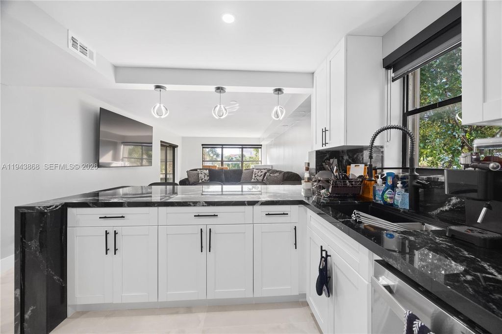 Photo of 2302 S Cypress Bend Dr #306, Pompano Beach, FL 33069 (MLS # A11943868)