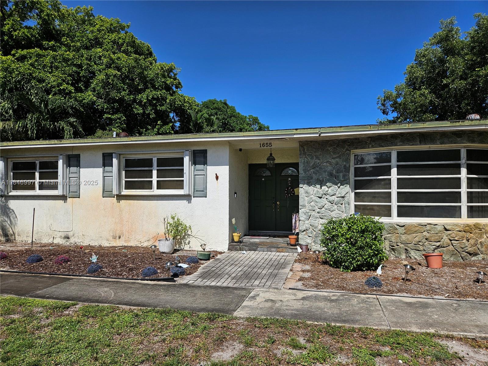 Unlock the potential! Situated on a spacious corner lot, this property offers great bones and a layout perfect for customization. While the home needs renovation, it presents the perfect canvas for investors or homeowners ready to make it their own. Interior and cosmetic updates are needed throughout, but the location and lot size offer a solid foundation for added value. Private backyard features a screened in-ground pool and sitting area to enjoy South Florida's tropical weather! The roof is approximately 23 years old with no known leaks, and the A/C will need replacement. Centrally located near shopping, schools, highways, and just minutes to the beach, this is a rare opportunity in one of Hollywood’s most sought-after neighborhoods. No HOA. Sold AS-IS.