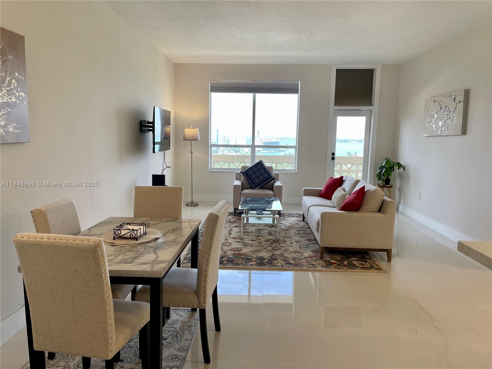 Amazing view of Bay Harbour Islands and Biscayne Bay from this ocean front Penthouse near Bal Harbour Shops. Magnificent sunsets. Unit is totally remodeled, 12 foot ceiling height, the second bedroom is a Den and the second bathroom with tub/shower. Master bathroom has an oversized shower and Toto toilet/bidet. New tile flooring throughout, made to order designer kitchen cabinetry and new top of the line stainless steel appliances. Fully furnished. Valet parking space #129. Building has oceanfront pool and beach service.
