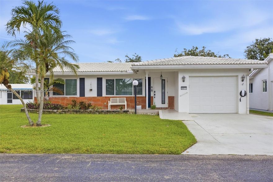 Beautifully updated residence in Lauderdale West, a well-established 55+ community in the heart of Plantation offering comfort, convenience, and an exceptional lifestyle. This spacious 2-bedroom, 2-bath home features a bright single-level layout with open living and dining areas, generous room sizes, abundant natural light, and a private 1-car garage equipped with dedicated EV charging capability. Substantially updated in 2023, the home showcases a beautifully renovated kitchen with modern cabinetry, quartz countertops, stainless steel appliances, stylish lighting, updated flooring, refreshed living spaces, and a beautifully renovated primary bathroom, creating a clean, modern, move-in-ready feel throughout. The thoughtful floorplan offers comfortable everyday living along with flexible space for entertaining, hobbies, or a home office setup. Partial impact windows provide added peace of mind and storm protection. Association-maintained exterior components support a low-maintenance lifestyle, while Lauderdale West residents enjoy access to clubhouse facilities, resort-style pools, spa, fitness amenities, tennis and pickleball courts, scenic walking paths, and a vibrant calendar of community activities. Ideally located near shopping, dining, parks, golf, medical facilities, and major roadways, this home offers an outstanding opportunity to enjoy the South Florida lifestyle at its best.