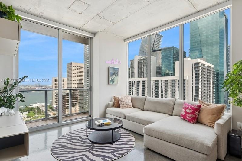 Elevated living awaits in the heart of Downtown Miami. As part of the coveted ’01 line, this 2 bed/2 bath corner loft boasts the largest & most desired floor plan at Centro. Enjoy sweeping views of Biscayne Bay & the city skyline through 10-ft, floor-to-ceiling windows or from your private balcony. Flooded w/natural light, this bespoke home offers a sleek modern kitchen, spa-style baths, polished concrete floors, an architectural wood panel wall w/concealed door & built-ins, customized closets & in-unit laundry. Lux amenities include rooftop pool, gym, sauna/steam, 2-level sky lounge & 24/7 concierge. Investors welcome w/high demand & flexible lease terms. Minutes to Bayfront Park, Metromover, Brickell, Kaseya Center, Whole Foods & world-class dining. Valet onsite or rental parking nearby.