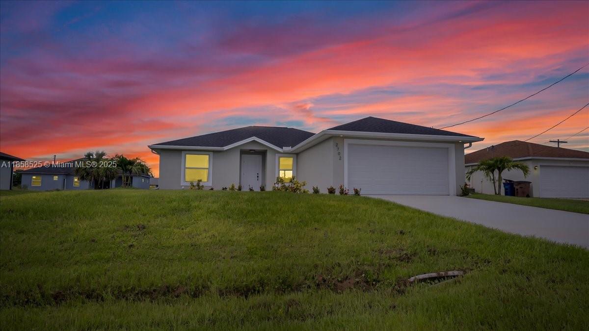 Be the very first to call this home (never lived in)—a brand new 2024-built 4-bedroom, 2-bath residence designed for modern living with impact-resistant windows and doors for ultimate safety and efficiency. The open-concept layout showcases vaulted ceilings, designer recessed lighting, and elegant tile flooring throughout, creating a bright, seamless flow from room to room. The striking two-tone kitchen is equipped with stainless steel appliances, a large island with breakfast seating, and ample cabinetry for storage. The private owner’s suite features a generous walk-in closet and a well-appointed en-suite bath, with beautifully tiled showers being installed in both bathrooms before closing. A full-home gutter system adds year-round protection.