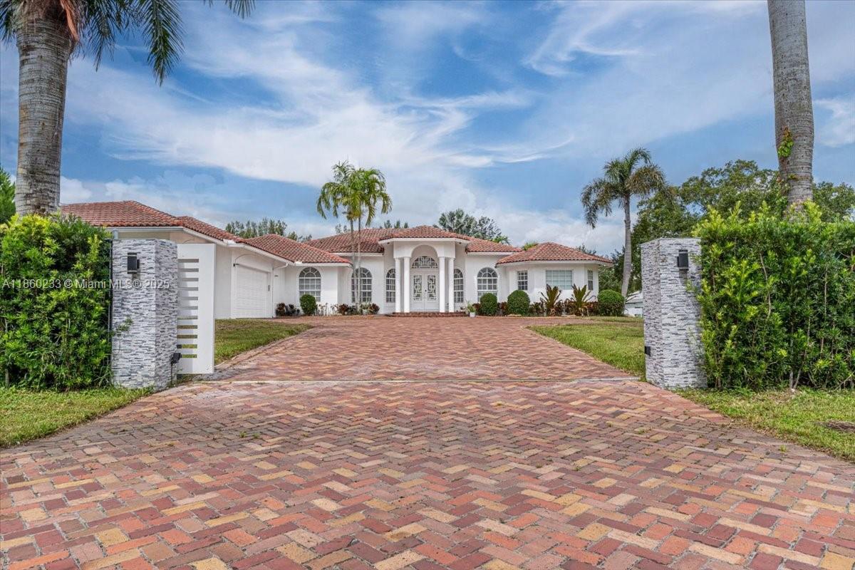 Amazing estate in 2 acre lot in the desired Southwest Ranches. Bright, modern home with high ceilings and open floorplan featuring 5 beds, 5 full baths, 1 half bath, office, large living area with electric fireplace, family room, 2 dining rooms. Custom kitchen with Viking appliances, large island, pantry, modern cabinetry and lighting. Beautiful, glass, climatized wine room, inside wet bar, patio with view to the pool. Large laundry with washer/dryer/sink, cabinets. 3-car garage with electric charger plus detached garage with storage, parking for cars and boat. Private dog area, horse barn. New gym with state of the art equipment, jacuzzi and sauna. Private beauty salon. High impact windows. Gated, automatic door, Ring and security system. Closed to Weston, top schools, shopping and more.