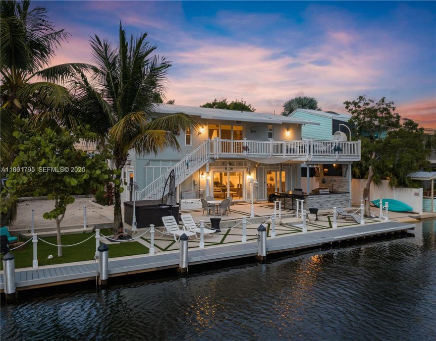 Boaters Dream Home in Key Largo. Discover this fully renovated 3-bedroom, 3-bath waterfront retreat. Designed for the ultimate coastal lifestyle, this property features an impressive 75-ft finished dock with direct access to Blackwater Sound, a private boat ramp, and a custom fish-cleaning station. Enjoy seamless indoor-outdoor living with a full outdoor kitchen, outdoor shower, and an eco-friendly jacuzzi. The property has undergone over $350,000 in high-end renovations, blending modern luxury with coastal functionality. The second floor offers two bedrooms, two bathrooms, a full kitchen, and a spacious balcony, making it ideal for guest accommodations or rental potential. The property was raised 18 inches above the original foundation to prevent flooding and saltwater intrusion.