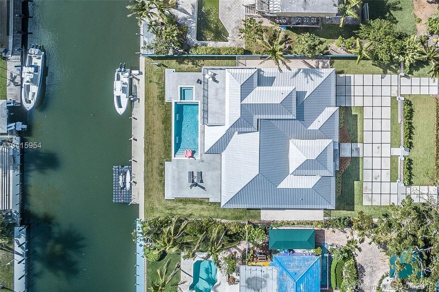 WATERFRONT NEW CONSTRUCTION.  Rare single family waterfront with large private dockage in N. Grove. 100' wide deep water canal can accommodate turning 65' boat.  No bridges to bay and direct ocean access on this private canal. 20,000lb boat lift and 22' floating dock with plenty of room in between to accommodate third boat. High ceiling open floor plan with clean lines make clean easy low maintenance living in a tropical & casual ambiance.  Incredible outdoor living space features deep porches to enjoy the outdoors rain or shine. Large upstairs terrace offers sun and bay breezes by day and extraordinary views of starlit skies of city lights at night. Perfect for cocktails before dinner!   *click link for virtual 360 tour*