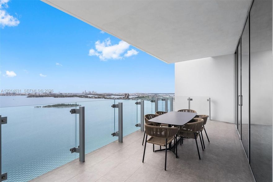 Welcome to elevated waterfront living at Missoni Baia, Edgewater’s premier luxury bayfront address. Residence 2803 showcases breathtaking panoramic views of Biscayne Bay and the Miami skyline through floor-to-ceiling impact glass and expansive terraces designed to maximize indoor-outdoor living. This beautifully appointed 2-bedroom, 2-bath residence features a sophisticated open-concept layout with porcelain tile flooring throughout, a sleek chef’s kitchen with custom cabinetry, premium integrated appliances, and an oversized waterfall island ideal for entertaining. The spacious living and dining areas are filled with natural light and framed by stunning water and city views from nearly every room.  The serene primary suite offers direct bay views, generous storage, and a spa-inspired bathroom with refined contemporary finishes. Missoni Baia offers an unmatched resort-style lifestyle with world-class amenities including three waterfront pools, a state-of-the-art fitness center with Pilates studio, luxurious spa with sauna and steam rooms, tennis courts, pet spa, kids’ club, game lounge, resident lounges, and 24-hour concierge services. HOA includes internet, cable, water, resort-style amenities, and assigned garage parking.