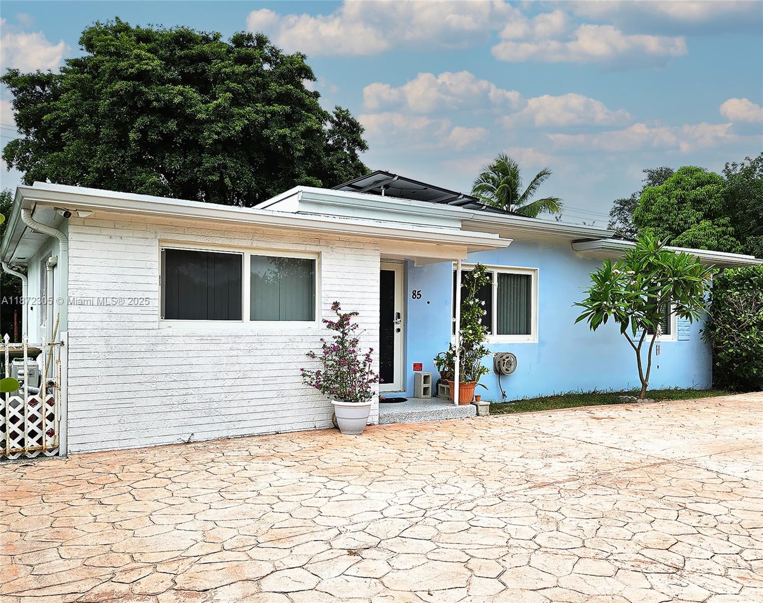 Welcome to this beautifully updated 4BD/3BA home in North Miami—offering the perfect blend of comfort, efficiency, and flexibility. Enjoy peace of mind with a new roof (2022), impact windows (2023), solar panels (2024), central A/C (2024), and mini splits (2023 & 2025) in both en-suite bedrooms, ideal for long-term guests or extended household needs. Smart home features include locks, lighting, and security cameras. The bright kitchen includes a tucked-away laundry area for added convenience. Step outside to a spacious fenced back yard with tropical landscaping, mango, sapodilla, and Plumeria trees. Stamped concrete driveway that fits 3–4 cars. A transferable solar lease keeps electric bills low, and the seller offers a credit for up to 24 months of projected solar costs. Quiet street.