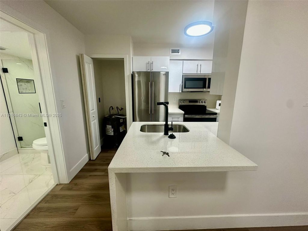 Photo of 2890 N Oakland Forest Dr #103, Oakland Park, FL 33309 (MLS # A11915843)