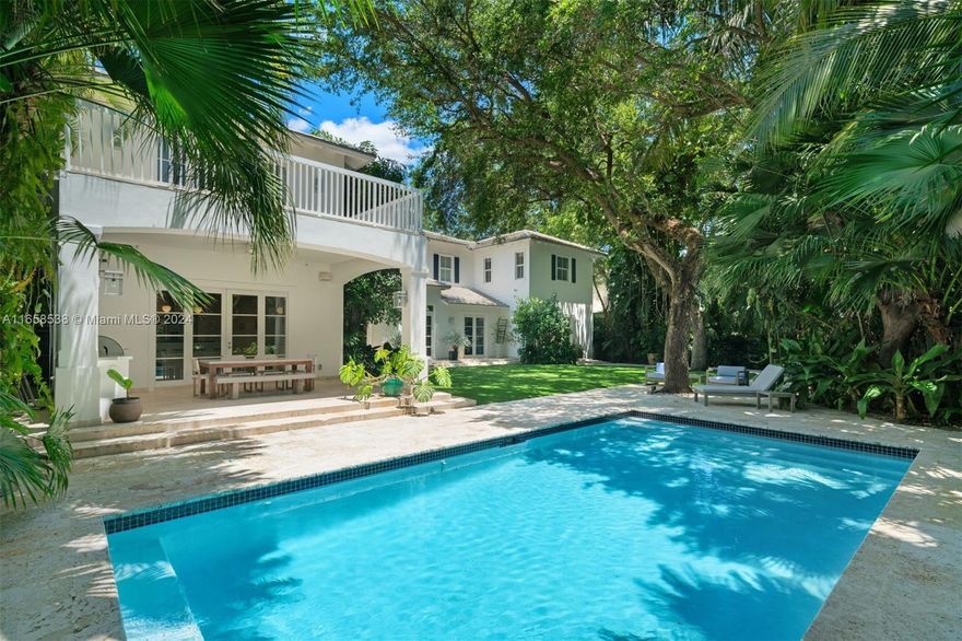 On a quiet street in south Coconut Grove, this stunning 7,001 SF, 6-BD 5.5-BA residence is on an expansive 14,750 SF lot. The primary suite has a large walk-in closet with custom built-ins, seating area, en-suite bathroom, and a private balcony overlooking the beautifully landscaped backyard. The gourmet eat-in kitchen includes an oversized island, high-end appliances, gas range, and a charming breakfast nook. The kitchen extends to a large family room that leads to a fully equipped summer kitchen and outdoor areas ideal for entertaining, with expansive covered patios, a pool, and turf. Highlights include an elevator, 2-car garage, ample parking with a Chicago brick driveway, and impact windows and doors. Short distance to the best schools, parks and the dining scene in the Grove.