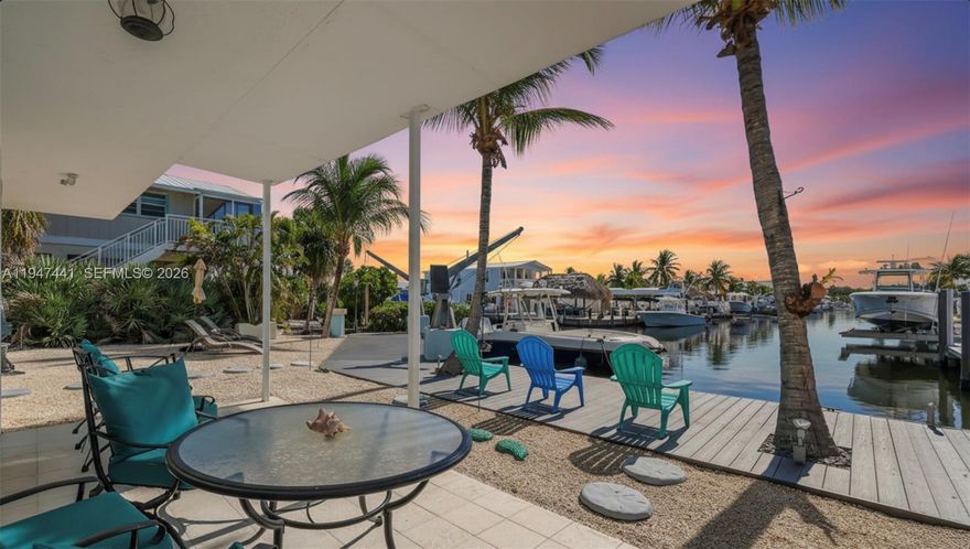 *Bayside Waterfront Living with Weekly Rental Income Potential* located within a private gated community in the Florida Keys. This concrete block construction residence offers 4bed and 3baths including a 1bd/1bth on the ground level with a separate entrance, ideal for guests, extended family, or flexible use. The main living level features an open layout filled with natural light and stunning water views, enhanced by a spacious wrap-around balcony perfect for outdoor living and entertaining. The kitchen, dining, and living areas flow seamlessly, creating a comfortable and functional space ideal for everyday living or hosting. Enjoy the true Keys lifestyle with a private dock and boat lift, providing direct bayside water access and convenient boating to the Atlantic via nearby channels. A standout feature of this property is that it allows weekly rentals, an extremely rare and valuable offering in the Florida Keys, making it well-suited as an income-producing asset. Additional highlights include multiple balconies, covered parking, and a separate downstairs living area, all within a secure, well-maintained community. Ideal as a primary residence, vacation home, or short-term rental investment, this property offers exceptional waterfront living with flexibility, privacy, and strong rental potential. *Owner Financing available*