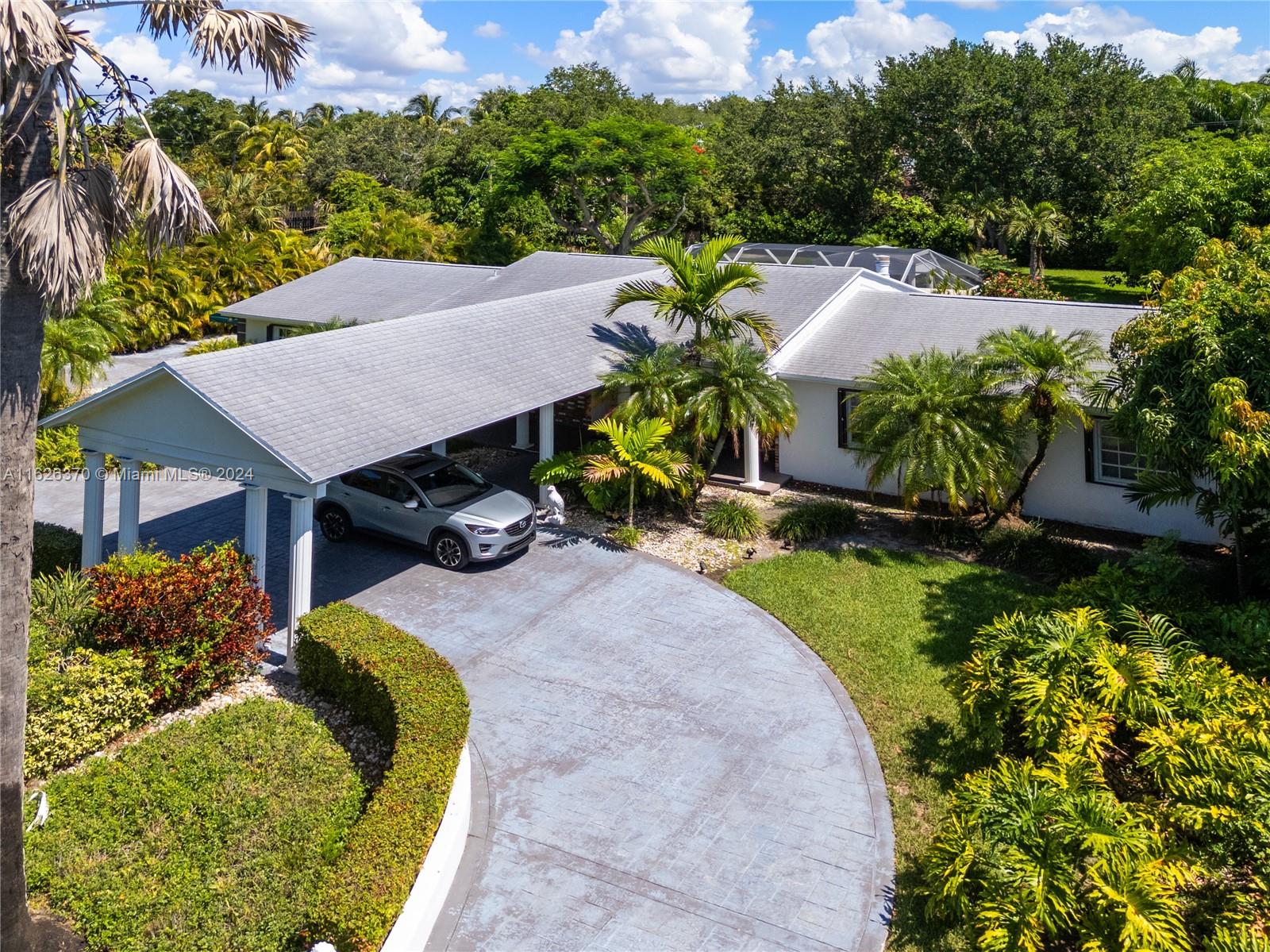 This exquisite 1-story residence, nestled on nearly an acre of pristine land, offers a harmonious blend of comfort and luxury. Boasting 4 spacious bedrooms and 3 elegantly designed bathrooms, this home provides ample space for both relaxation and entertainment. The expansive backyard is a true oasis, featuring a covered screened patio perfect for year-round enjoyment, and surrounded by greenery. This property embodies the essence of tranquil living, making it the perfect retreat for those seeking both privacy and convenience. Near Pinecrest Elementary School, Miami Palmetto Senior High, Palmetto Middle School.