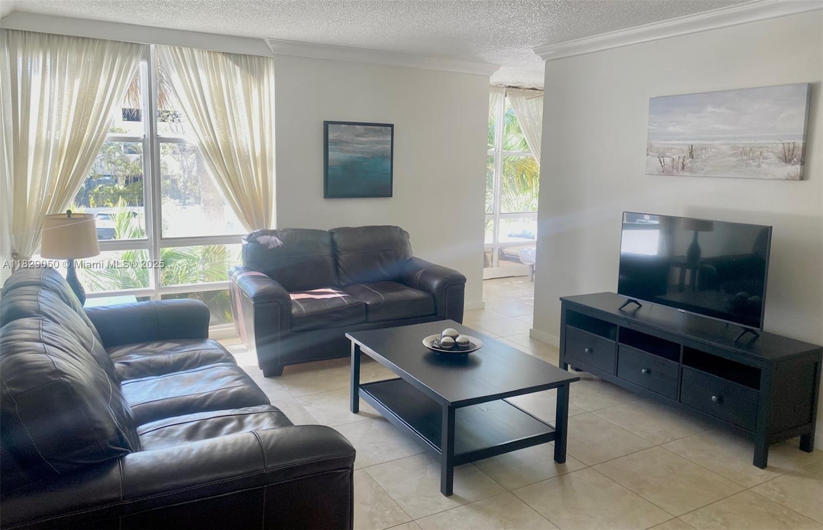 LIVE ACROSS FROM THE BEACH! This fully furnished 1 bedroom + den, 1.5 baths is located in the most coveted neighborhood in Florida, surrounded by iconic luxury buildings like Porsche, Armani, Bently, Turnberry towers and others. The master bath is beautifully renovated with a glass walk-in shower and a double vanity. The den could be used as a second bedroom, office or even a breakfast/dining area. AC unit is aprox 1.5 years old. The building has the following amenities: a big heated swimming pool, sauna, gym, billards room, event room and 1 assigned parking space. It is undergoing exterior upgrades including a new roof. Just steps from a gorgeous supermarket, shops and fine dining. This is your piece of PARADISE! Come see it today!