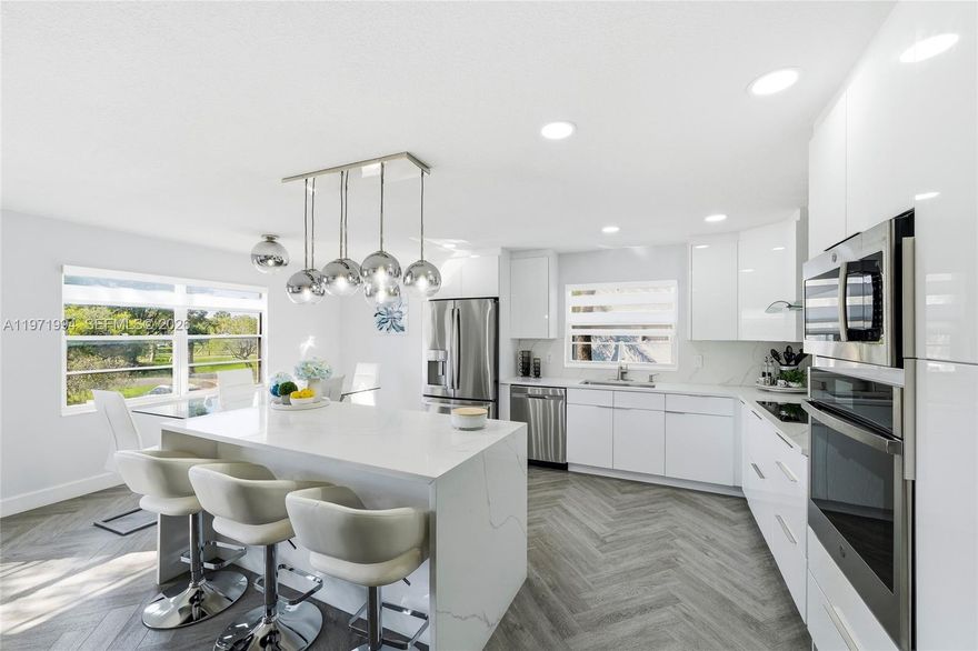 Beautifully maintained and thoughtfully redesigned condo in Century Village. This exceptional unit blends contemporary elegance with everyday comfort. Move-in ready and ideal for buyers seeking style, convenience, and an active lifestyle. Upon entry, you are welcomed by a bright, open layout filled with natural light, the chef-inspired kitchen is a true focal point, featuring a striking quartz waterfall island, stainless-steel appliances, and sleek European-style cabinetry. One bedroom offers a private balcony with relaxing pool views, while the spacious primary suite includes a walk-in closet and a beautifully updated bathroom designed with modern finishes. The home has been fully remodeled with attention to detail and includes a New tankless water heater, A/C (2023), an on-site storage unit providing valuable additional space. Enhancing the lifestyle appeal, the unit is ideally positioned across from a brand-new walking park, perfect for reading, relaxing, or enjoying daily exercise. From the patio area, residents can appreciate scenic views of the pool and nearby tennis courts, convenient access to the community health club gym featuring fitness classes, an additional exercise pool, and an extensive array of amenities in the Million dollar Club House. This is a rare opportunity to own a turnkey, designer-inspired residence in a prime location with resort-style living and unmatched convenience — schedule your private showing today!