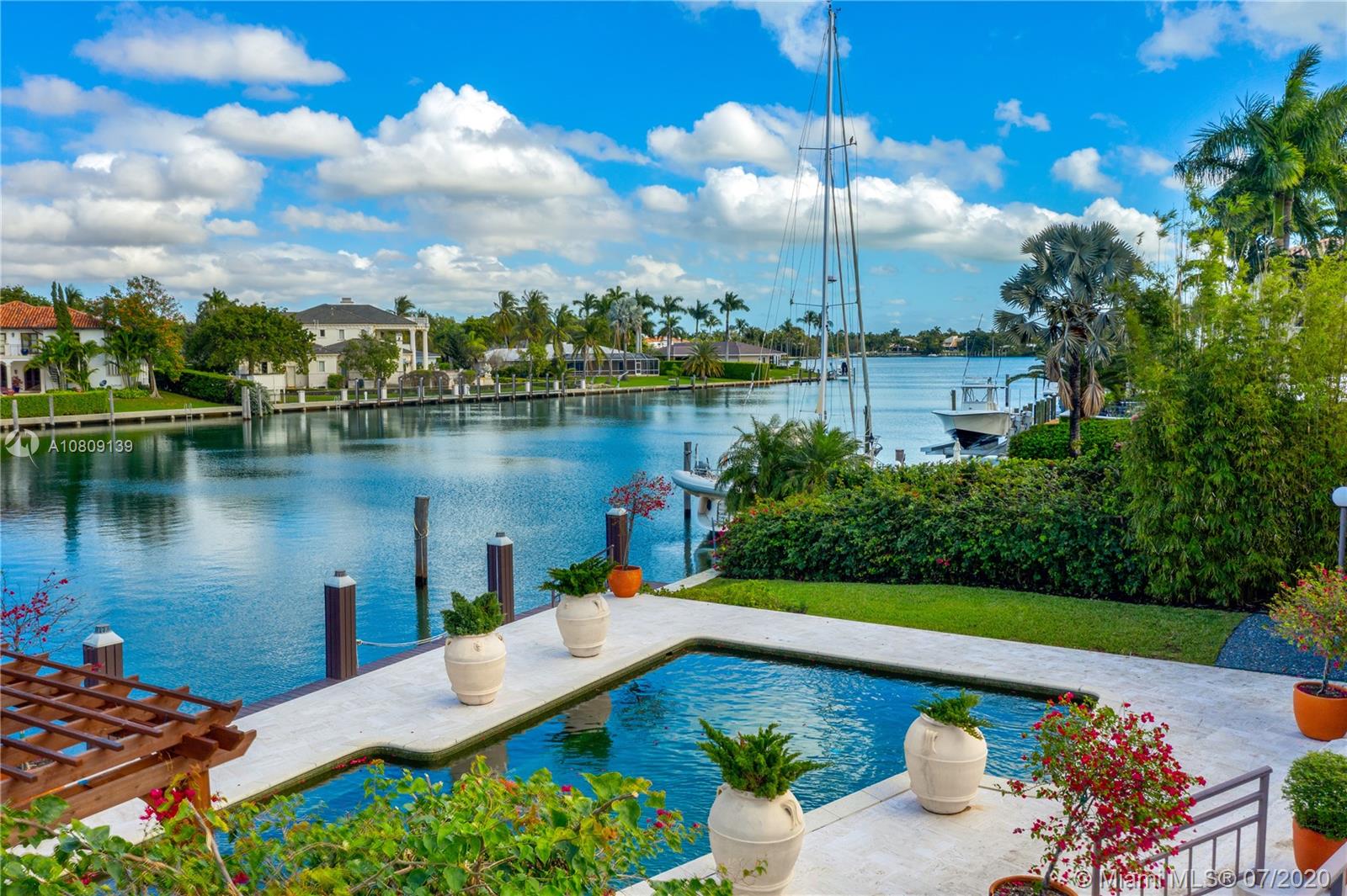 Best opportunity to live in Old Cutler Bay. No bridges to Bay. Great wide lagoon views from entire home. Timeless design, high ceilings, and sliding glass doors frame pool and wide water views. New spa, master bath, and bedroom wood floors. Fresh and contemporary, very open to large terrace, pool deck, dock and yard, Den off family room convertible to bedroom. Ground level terrace with cabana bath. Bonus area includes rec room and additional bathroom. SF is adjusted as per Tax Roll. LA & TA not available. Kitchen needs new appliances + remodel. Guard gated neighborhood with roaming patrol/Special Tax District.