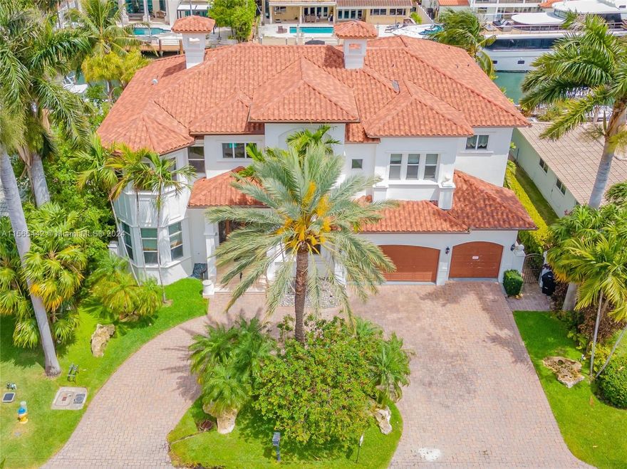 This luxurious 2 Story waterfront home was built in 2003. Many custom features. High ceilings, 8FT doors, OPEN & SPACIOUS floor plan. Boat Dock for up to 85ft yacht. Interior elevator, wet bar, marble floors downstairs & up except bedrooms. Hurricane impact windows & doors thru-out. Gourmet island kitchen with Wolf Gas Stove. Huge master suite and bathroom with walk thru shower with separate spa, 2 large custom walk in closets, large balcony overlooking pool-spa & water. 3 car garage with circular driveway. Huge gas Kohler generator runs house with 4 large propane tanks. Located in the 24hr guard-gated community of Eastern Shores and just minutes to the Beach & Haulover Inlet. Walk to shopping, waterfront dining & I-pic movie theaters. Owner may hold a first Morgage with 50 percent down.
