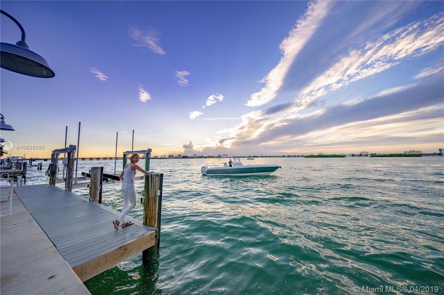 Extraordinary waterfront home radiates style & elegance w/ unobstructed west facing sunset views. Set amid a 14,000SF lot, residence offers 80ft of wide water frontage w/no fixed bridges, 50ft boat dock / lift, summer kitchen, covered patio, & pristine pool. Impressive 5,334SF of total SF features a soaring 20’ ceiling w/ skylights in the great room, gourmet eat-in gas kitchen, formal dining room, bayfront family media room, separate office, & 3 beds downstairs. 2nd story is dedicated to impressive master retreat offering walk-in closets, spa-like bath w/double sinks, & fabulous water views from the expansive balcony. Sit back, enjoy the sunsets, & watch the dolphins swim by in this tranquil residence on the bay. 3D INTERACTIVE TOUR @ https://my.matterport.com/show/?m=X4Sp3zub7QN&mls=1