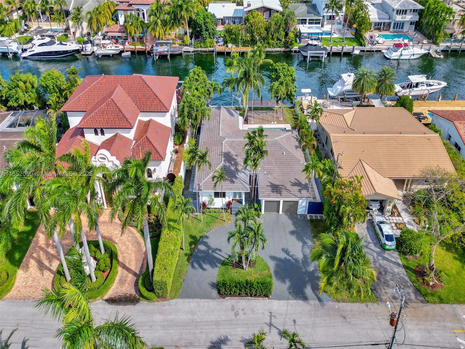 Experience Miami, Waterfront Living. Gorgeously Renovated, Abundant Natural Light: Open Floor Plan, Custom Millwork w/ Flex Space 2-Car Garage. Per Updated Survey owner reports 2,287 SF of Interiors that effortlessly blends Indoors & Outdoors. Enjoy ALL NEW: Dock, Custom Closets, A/C Units, Tankless Water Heater, Electrical, Roof, Landscaping, Fence, Exterior Lighting and more. BOATER'S PARADISE w/ 75 ft Waterfront, No Fixed Bridges, Direct Ocean Access, & Shore Power. Sans Souci is a single-entrance gated community w/ Police stationed at the Guard House. Situated on Biscayne Bay directly across from Indian Creek & Bal Harbour. Minutes to The Design District & Aventura and ocean.