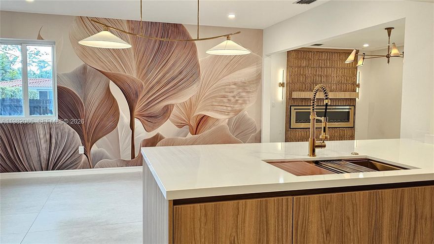 This single family home is in one of the most sought after neighborhoods, Silverbluff which is located north of Coconut Grove and south of Shenandoah.  This is a beautifully renovated mid-century modern home that was tastefully done in an organic modern feel.  The home is a 4 bedroom 3 bathroom home that is perfectly situated with 2 primary suites perfect for in-law, nanny, guest, or teen quarters.  The living room has a custom designed electric fireplace that compliments the kitchen cabinets and kitchen backsplash tile with a gorgeous dining room mural that combines all the textures with the warmth of a home but the appeal of a modern condo.  There is a designated room perfect for a theatre, gaming, family room, or children's play area.  Part of the home can be easily separated to make a designated full in-law or a massive primary quarters.  The home sits on a corner lot which provides two designated fenced in yard spaces.  One space is perfectly designed for outdoor entertaining with wood decking tiles and string lights.  The exterior does have a well system and pump for sprinklers, extra parking in the rear of the home, and exterior lighting.  This home does have a full single car garage that can easily be converted into more storage space, flex zone, or a full gym.  This is a must see home that has been tastefully done to meet any buyer's needs.