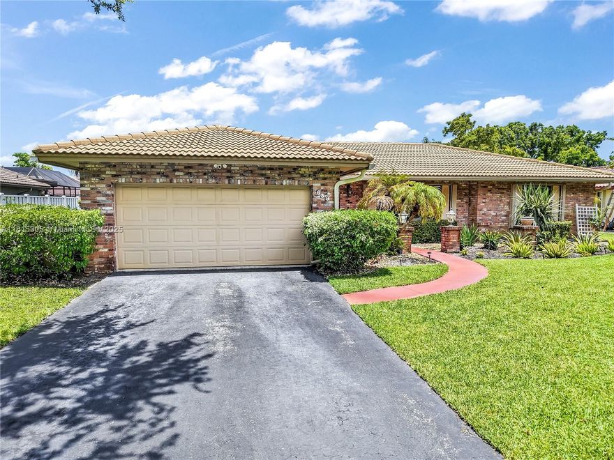 Immaculate 3-bed, 2-bath ranch in the coveted Oakwood community, steps from Whispering Oaks Park. Nestled on an oversized, tropically landscaped lot, this bright, open home features vaulted ceilings, wood floors, and lots of windows. Formal living/dining rooms and a spacious family room make it perfect for everyday moments and entertaining. The updated kitchen offers cherry wood cabinets, quartz counters, stainless appliances, double ovens, a ceramic cooktop, and large island. Remodeled baths, new flat patio roof (2023), newer A/C, and water heater. Main roof (2002). Enjoy a large screened patio and room for a pool. Zoned for top schools and centrally located in Coral Springs.