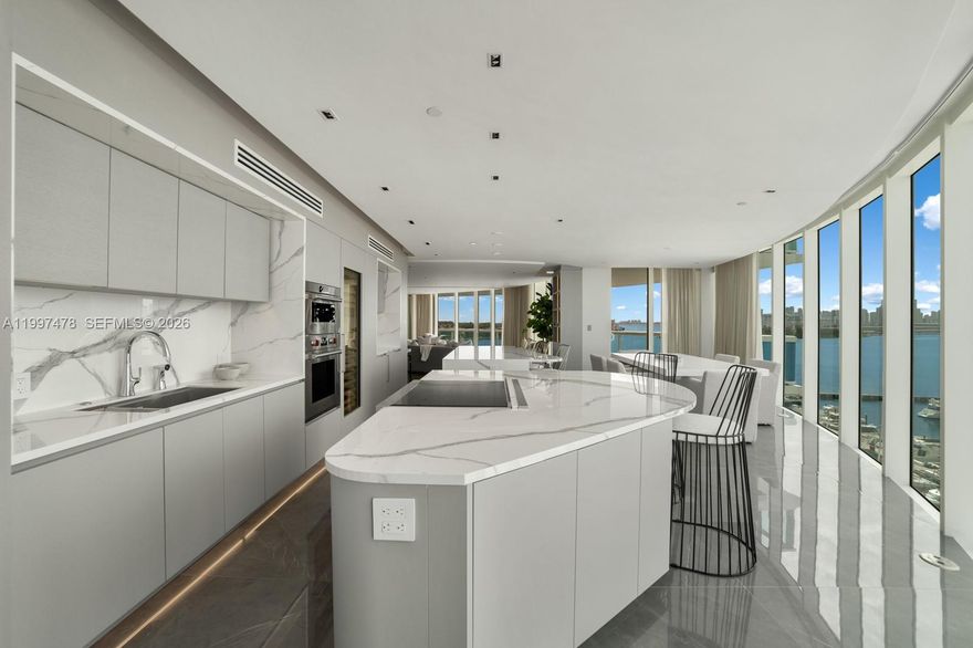 Completely renovated and reconfigured sought-after Murano Portofino 01 line in South of Fifth. Never lived in, this residence offers the largest 3-bedroom layout in the sofi. Thoughtful redesign includes a proper hallway to private guest suites, all en-suite with closets. Features include dual walk-in closets, double vanities, seamless custom storage, and a full AV system. Chef’s kitchen with double islands, double fridge 4 freezer drawers, ice maker, and three wine fridges—ideal for entertaining and chef. Expansive ~14-ft deep terrace with room for outdoor living and dining. Enjoy Miami’s most iconic view of Miami Beach marina, bay, and downtown skyline sunset views with ideal exposure wind/ sun exposure.