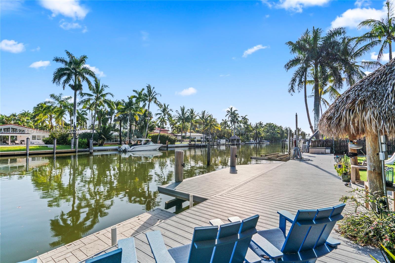 Boater's paradise in the exclusive, guard-gated community of Belle Meade. This charming 3-bed/2-bath home boasts 100 feet of water frontage on an oversized 15,000 SF lot. Capturing the essence of Florida Keys this spacious backyard, complete with a pool, jacuzzi, tiki hut, and lush landscaping, is perfect for outdoor gatherings. With no fixed bridges to Biscayne Bay, this property is ideal for boating enthusiasts. It includes a boat lift and deep-water dockage.