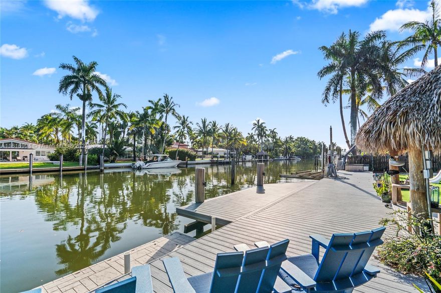Boater's paradise in the exclusive, guard-gated community of Belle Meade. This charming 3-bed/2-bath home boasts 100 feet of water frontage on an oversized 15,000 SF lot. Capturing the essence of Florida Keys this spacious backyard, complete with a pool, jacuzzi, tiki hut, and lush landscaping, is perfect for outdoor gatherings. With no fixed bridges to Biscayne Bay, this property is ideal for boating enthusiasts. It includes a boat lift and deep-water dockage.