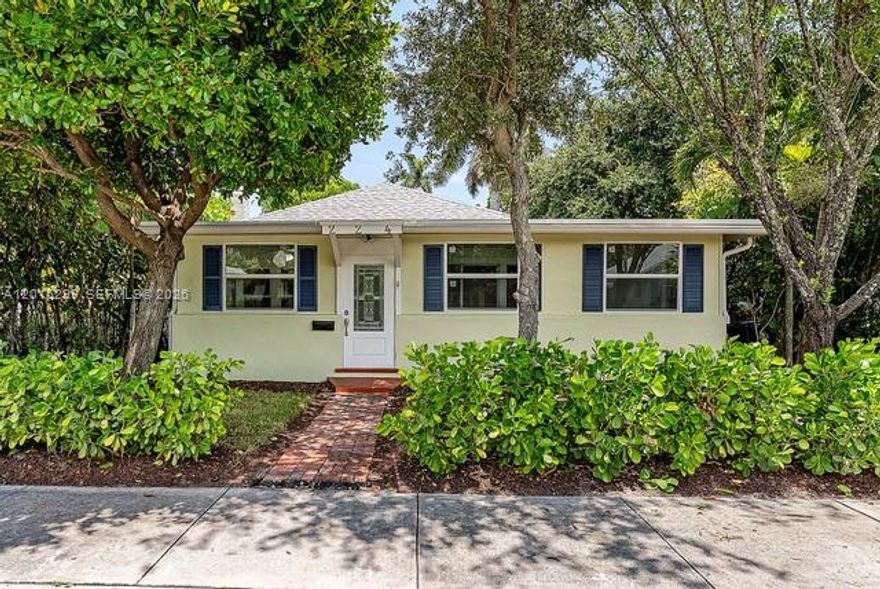 Nestled in the heart of Lake Worth Beach’s historic district, this restored 1920s residence blends timeless character with design-forward luxury. Original 1920s pine floors refinished in a Loba Whitener stain flow throughout sunlit interiors. A striking entryway features Noir Moon honed marble and Bianco Carrara honed marble in an Aris Edge field tile pattern. Craftsmanship continues into the custom laundry room, where Venezia terrazzo floors are paired with bespoke cabinetry. The home offers two spa-inspired bathrooms. The “Green Bathroom” showcases Calacatta Green honed hexagon marble mosaic floors, Zia Zellige “Tide Pool” shower tile, and fixtures by Signature Hardware, complemented by a Birch Lane vanity, Lyngard lighting, and Rejuvenation hardware. The “White Bathroom” features Arabescato D’Oro honed hexagon marble floors, glossy Cloud White Zellige shower tile, a Signature Hardware soaking tub and fixtures, along with a Birch Lane vanity, Lyngard lighting, and Rejuvenation hardware. The chef’s kitchen is appointed with custom cabinetry and a full suite of Fisher & Paykel appliances, including a 36” refrigerator/freezer, five-burner self-cleaning range, integrated dishwasher, and perimeter insert range hood. A Blanco Precis single-basin Silgranit sink, Lyngard lighting,and Rejuvenation hardware complete the space. The living area is anchored by a cast-stone fireplace with a distressed ivory sand finish. Brand-new impact windows enhance energy efficiency and natural light