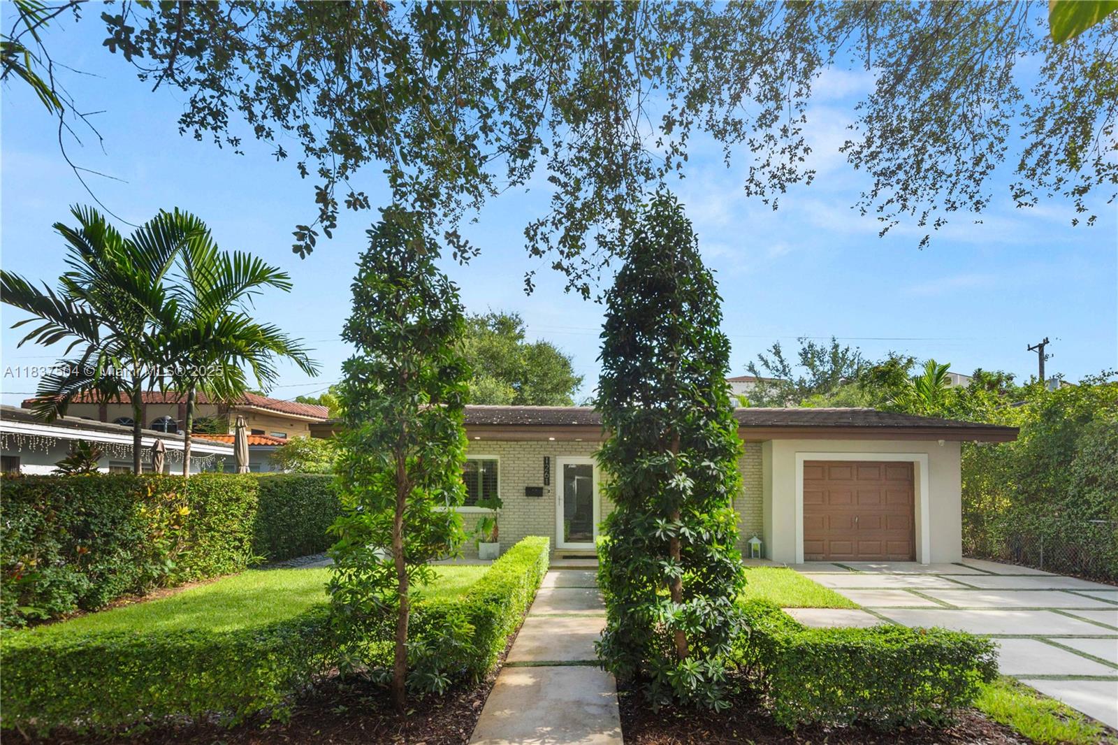 Beautiful and completely turn-key home in the North Gables. 3-bedroom, 2-bath with a one car garage. This beautiful home sits on a beautiful tree lined street with impeccable curb appeal. Open plan kitchen with quartz counters, stainless steel appliances and plenty of room to cook while entertaining. The home has Impact windows and doors as well as security cameras and an artificial fireplace. This home has a back yard aluminum Gazebo with a TV and sitting area. The back yard has artificial grass and a dining area on the side. The home is gated, professionally landscaped and ready for a new family to make it their home. This is a turn-key home that is priced as a fixer upper!