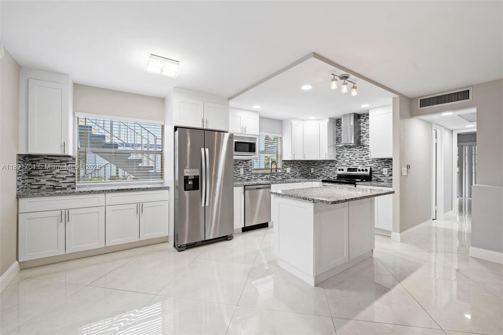 Must see! BEAUTIFULLY RENOVATED, extended OVERSIZED open kitchen — one of the LARGEST in Kings Point. 1st Floor 2B/2B condo with garden view in Kings Point & Country Club 55+ gated community. New wood cabinetry in kitchen & baths, new baseboards, granite countertops, new stainless-steel appliances, energy-efficient LED lighting across an open floor plan. Notable features include 32 x 32 diagonal flooring throughout. Stunning bathroom designs include ultra-contemporary touch to activate lighting built-in to vanity mirrors. Includes ceiling fans throughout, window treatments, built-in floor to ceiling dressing mirror & a remote-controlled electric decorative fireplace. Enclosed patio with A/C, washer & dryer. Pool, 3 multi-million dollar clubhouses 2 Executive Golf Courses & more.