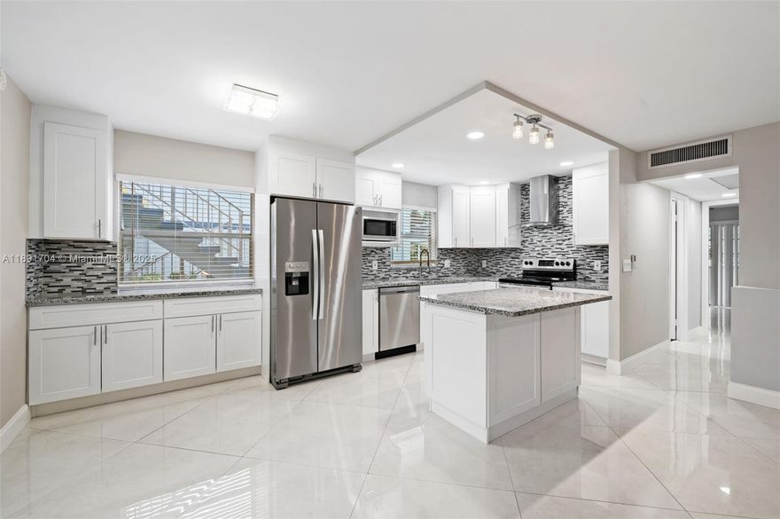 Must see! BEAUTIFULLY RENOVATED, extended OVERSIZED open kitchen — one of the LARGEST in Kings Point.  1st Floor 2B/2B condo with garden view in Kings Point & Country Club 55+ gated community. New wood cabinetry in kitchen & baths, new baseboards, granite countertops, new stainless-steel appliances, energy-efficient LED lighting across an open floor plan. Notable features include 32 x 32 diagonal flooring throughout. Stunning bathroom designs include ultra-contemporary touch to activate lighting built-in to vanity mirrors. Includes ceiling fans throughout, window treatments, built-in floor to ceiling dressing mirror & a remote-controlled electric decorative fireplace. Enclosed patio with A/C, washer & dryer. Pool, 3 multi-million dollar clubhouses 2 Executive Golf Courses & more.