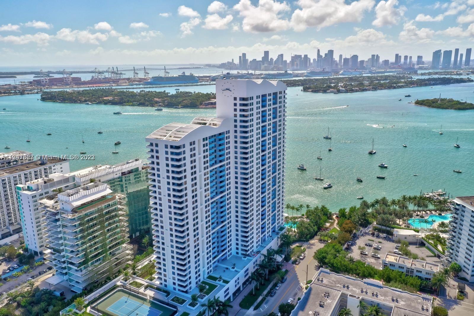 Designer model upgraded 26th floor with amazing bay and ocean views. Fully upgraded w/ top-of-the-line appliances and kitchen cabinets, wood floors, renovated bathrooms and reconfigured walls. Peaceful West Ave location, walking distance to restaurants, Lincoln Road, Whole Foods, and much more. This is a 24-hour full-service building. amenities include pool, gym, yoga room, tennis, volleyball & bayfront BBQ. 2 Parking spaces, 1 assigned and 1 valet.