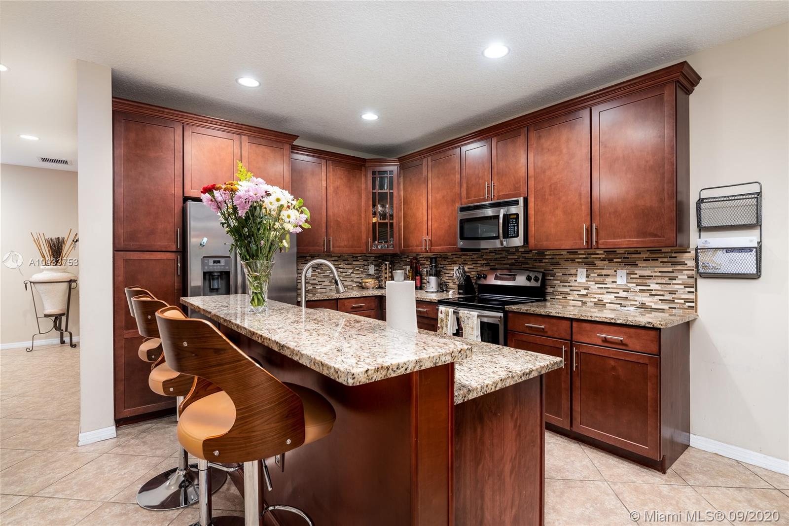 Amazing opportunity in Davie! This Avanti end-unit model built in 2015 is one of the largest in the Belle Tara complex, featuring 3-bedrooms and 3-bathrooms with an optional 4th bedroom or den. Premium upgrades to the property include wood floors throughout the second story, matching custom cabinets throughout the entire property, impact windows, and beautiful granite in both the kitchen and bathrooms. Great open floor plan downstairs with the kitchen flowing into the living and dining rooms. Complex is centrally located, easy access to highways, bring all Buyers they will love this. Full Bathroom downstairs, Gorgeous Master Room ***MUST SEE****