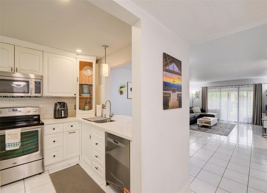 Best-Priced Opportunity in the Area! Beautifully remodeled ground floor corner condo in desirable Coconut Creek offering 2 bed 2 bath with peaceful canal and green space views. Bright spacious residence features an open layout, tile flooring throughout the main living areas, generous living, dining spaces, sliding glass doors leading to a private screened patio ideal for relaxing or entertaining. Updated kitchen showcases white cabinetry, quartz countertops, stainless steel appliances, breakfast bar, ample storage,  dishwasher 2024, opening seamlessly to the living area. The expansive primary suite offers wood style flooring, recessed lighting, oversized mirrored closets, and a remodeled private bathroom with modern walk in shower. Guest bathroom has also been tastefully updated. Additional features include full size washer and dryer 2024, water heater 2024, HVAC estimated 2013-2016, modern fixtures, generous storage, and the added privacy of a well maintained corner unit. Association fee includes roof maintenance, water, cable TV, and pest control. Enjoy Township resort style amenities including clubhouse, pools, fitness center, tennis courts, basketball courts, scenic walking paths, parks, lakeside areas, and outdoor spaces. Prime location minutes from The Promenade at Coconut Creek, Publix, dining, shopping, everyday essentials, major highways, nearby schools. Excellent opportunity for buyers seeking comfort, convenience, upgrades, water views, and South Florida living.