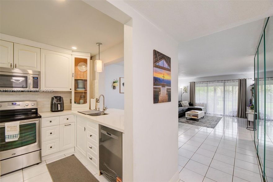 Seller motivated and open to concessions with acceptable offer!! Beautifully remodeled ground-floor corner condo offering 2 bedrooms and 2 bathrooms in a serene canal-front setting. Bright and open layout features tile flooring throughout the main living areas, spacious living and dining rooms, and sliding glass doors leading to a private screened patio with tranquil canal and green space views—perfect for relaxing or entertaining.
The updated kitchen showcases white cabinetry, quartz countertops, stainless steel appliances, a breakfast bar, and a new dishwasher (2024), opening seamlessly to the living area. The expansive primary suite features wood-style flooring, recessed lighting, oversized mirrored closets, and a remodeled bathroom with walk-in shower and modern finishes. The guest bathroom has also been tastefully updated.
Additional highlights include full-size washer and dryer (2024), recessed lighting, modern fixtures, generous storage, and a well-maintained corner-unit location offering added privacy.  Minutes from The Promenade at Coconut Creek offering dining and shopping, plus convenient access to Publix and everyday essentials. ASSN FEE INCLUDE ROOF MAINT, WATER, CABLE TV PEST CONTROL.  Enjoy nearby parks, walking trails, Township resort-style amenities clubhouse, pools, fitness center, tennis  basketball courts, scenic walking paths, peaceful lakeside areas—all in a prime Coconut Creek location with easy access to major highways and top-rated schools nearby.