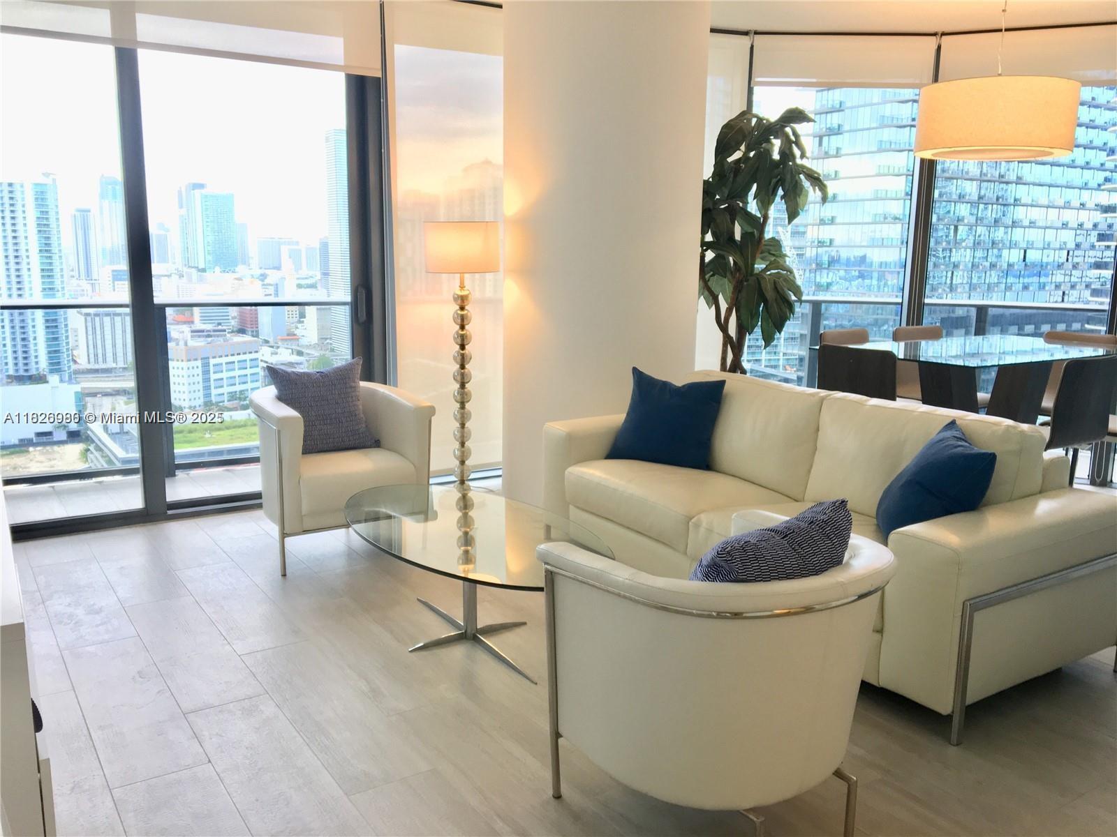 With a huge wrap-around balcony with panoramic views of the Miami River and skyline, this luxury condo is located in the center of Brickell. This unit receives direct sunlight from sunrise to nightfall thanks to floor to ceiling impact glass doors and windows. Corner property with a split floor layout with two bedrooms, two bathrooms, plus a den for added comfort. This turnkey unit comes fully furnished and outfitted in its entirety. Building featuring full-service amenities, including a concierge, gym, spa, two rooftop pools, one assigned parking space, and much more. The best parking space in the whole complex. All of Brickell's top spots are accessible on foot. Short term lease available.