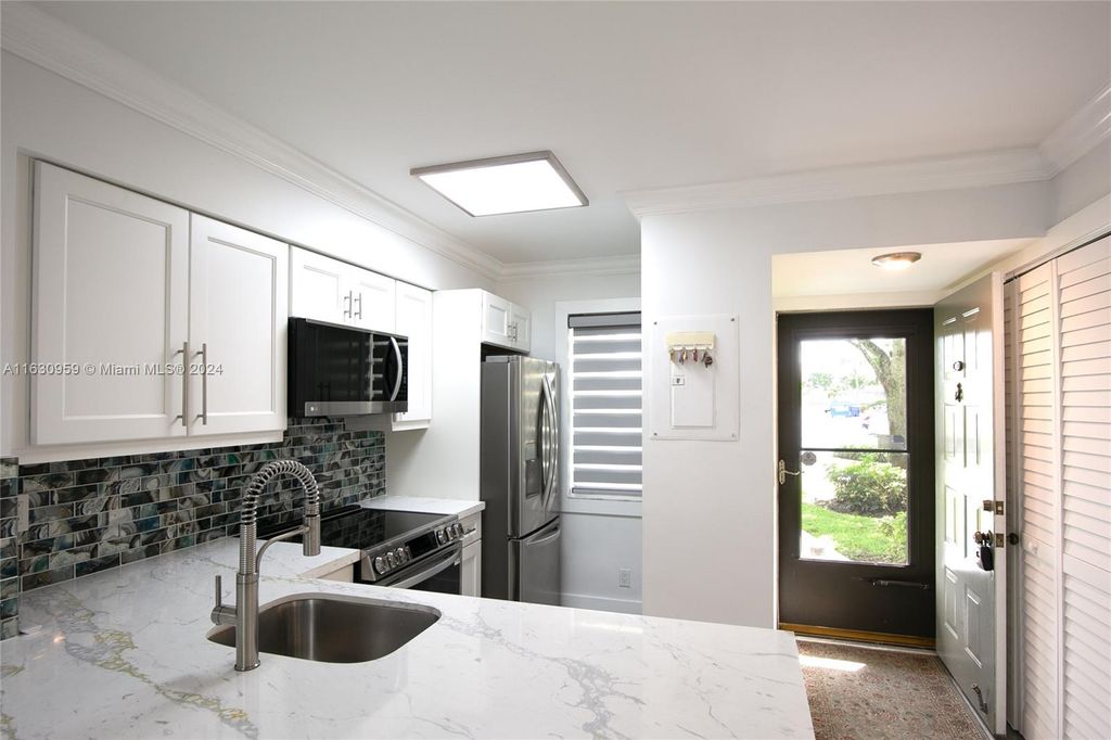 Photo of 2226 N Cypress Bend Dr #103, Pompano Beach, FL 33069 (MLS # A11630959)